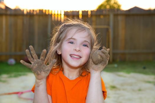 children girl playing with mud sand ball and dirty hands smiling happy