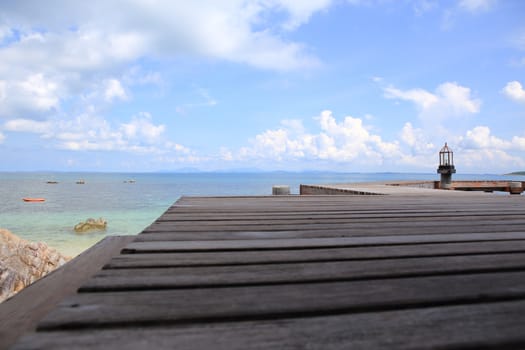 Wooden jetty on tropical beach on island