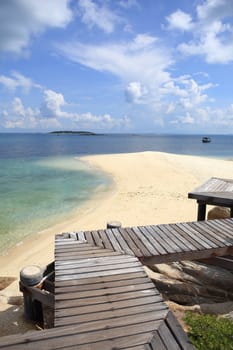 Wooden jetty on tropical beach on island