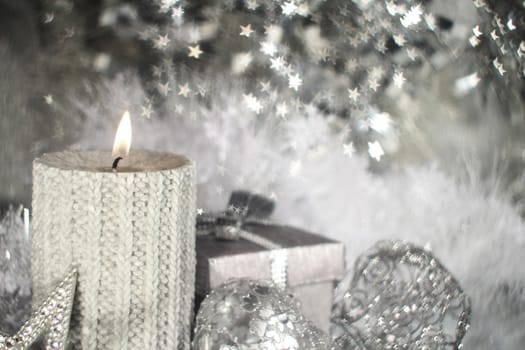 Christmas candle with gift and different silver decoration