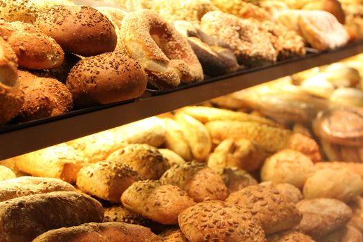 different appetizing bread on showcase in supermarket