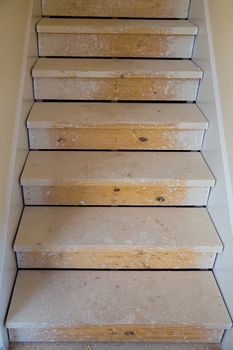 Wooden stairs in new house construction before painting process