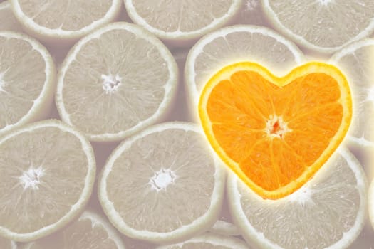 Orange cross section shaped like heart on slice background