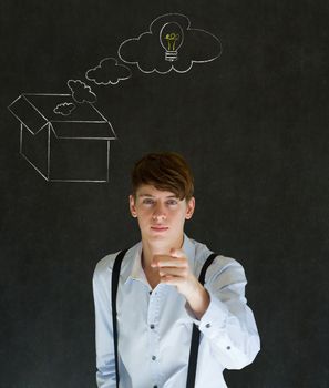 Businessman, student or teacher thinking out the box chalk concept blackboard background