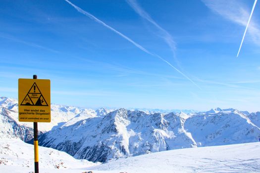 Danger sign High mountains under blue sky beautiful winter panorama