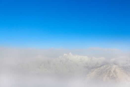 Beautiful panorama of foggy mountain peaks in winter