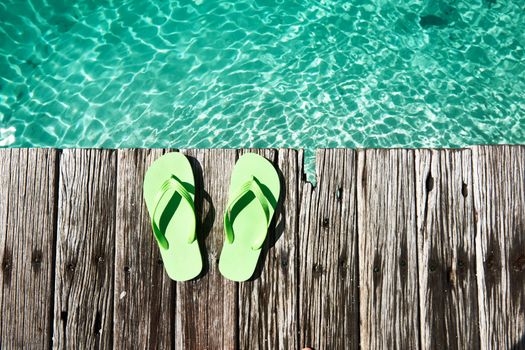 Slippers at jetty by the sea
