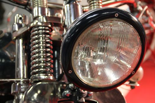 Shiny motorcycle headlight macro close up