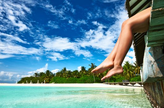 Woman's legs at beach jetty