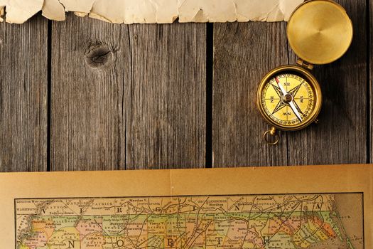 Antique brass compass over old map
