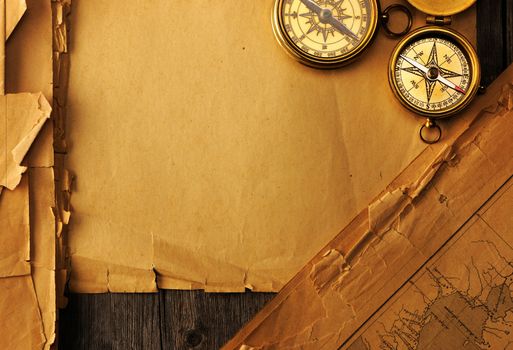 Antique brass compass over old map