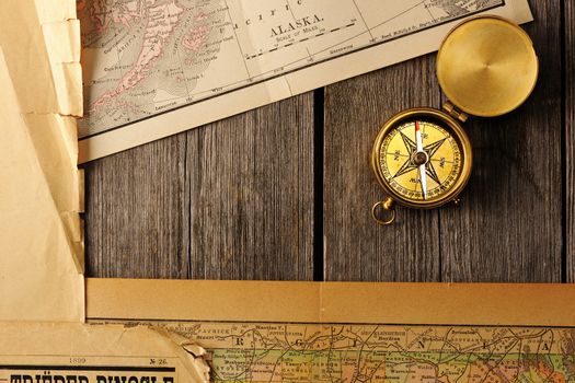 Antique brass compass over old map