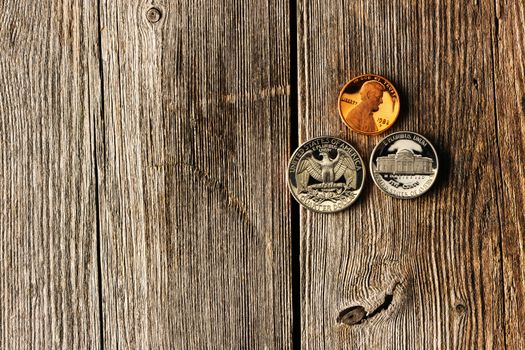 Three US cent coins over wooden background