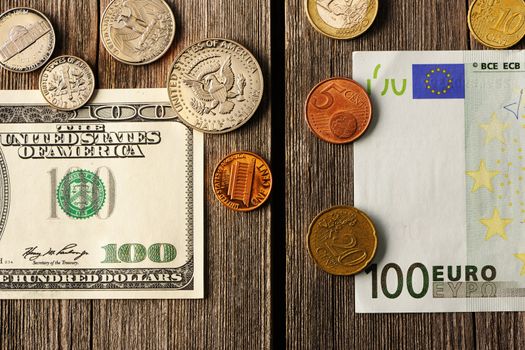 US and euro currency over wooden background