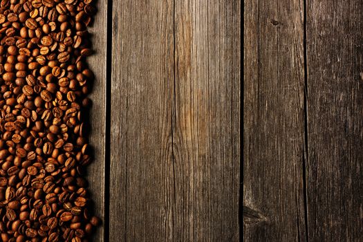 Coffee beans over wooden background