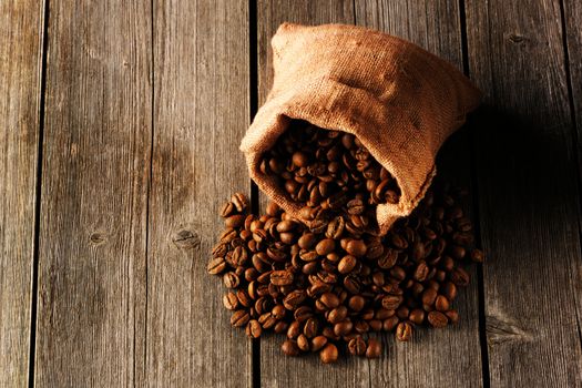 Coffee beans in bag on wooden table