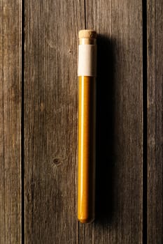 Ras el hanout in beaker on wooden background