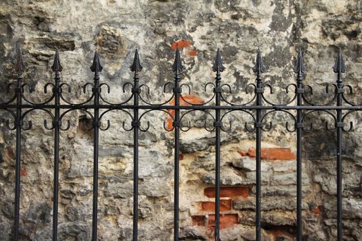 Old grill and ancient wall in Tallinn