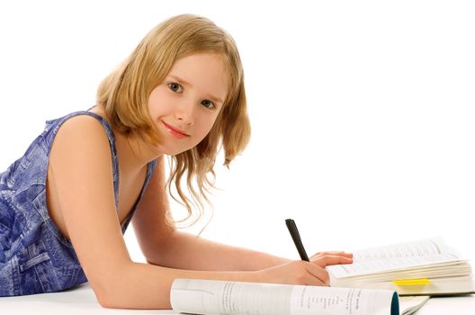 Blonde Girl Lying Down and Studying with Books, Exercise Book and Pen on white background