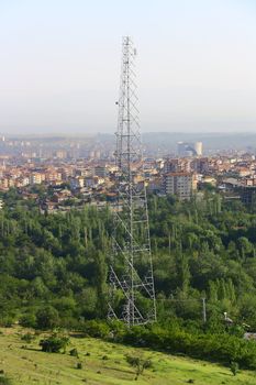 mobile phone antenna on the hill of city with city view