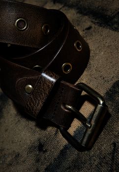 Close-up photo of the leather belt on textured background