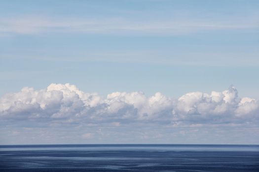 Blue ocean and bright sky with beautiful clouds