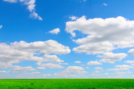 Beautiful landscape of plain field under cloudy blue sky