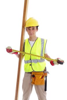 Apprentice builder or carpenter holding a tape measure and pieces of timber wood.  White background.