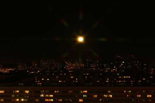 Beautiful night city panorama under shiny moon
