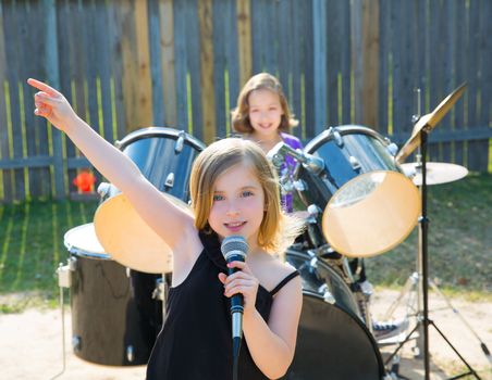 Blond kid singer girl singing playing live band in backyard concert with friends