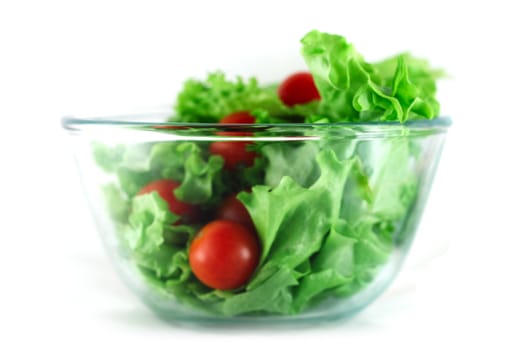  Lettuce and cherry tomatoes salad in transparent bowl isolated on white 