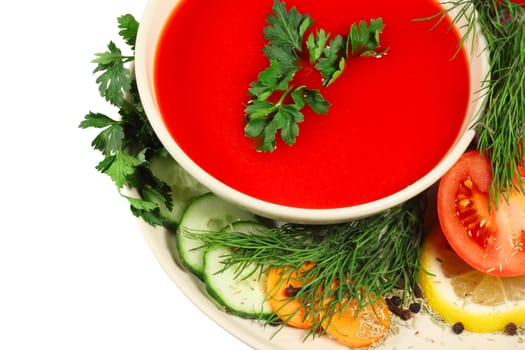 Fresh tomato soup with different vegetables isolated on white