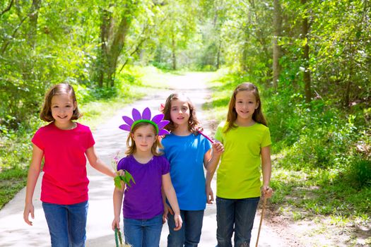 Friends and sister girls walking outdoor in forest track excursion
