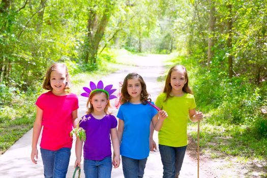 Friends and sister girls walking outdoor in forest track excursion