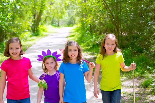 Friends and sister girls walking outdoor in forest track excursion