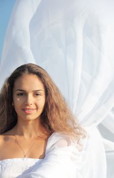 Portrait of a young woman wearing white dress outdoors