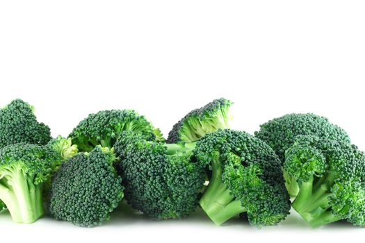 Fresh broccoli pieces in row isolated on white background