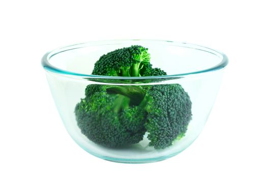 Fresh broccoli pieces in transparent bowl isolated on white background