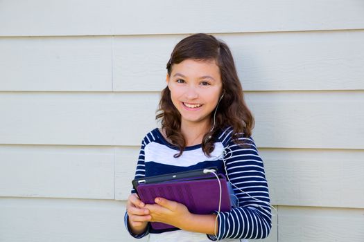 Teen girl happy holding tablet pc and earings smiling