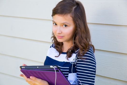 Teen girl happy holding tablet pc and earings smiling