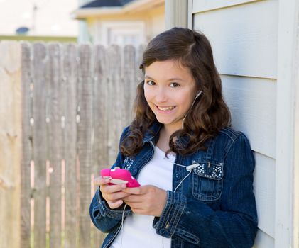 American latin teen girl playing music with smartphone earings