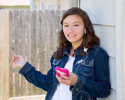 American latin teen girl playing music with smartphone earings