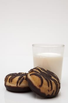 glass of milk with chocolate donut on a white background