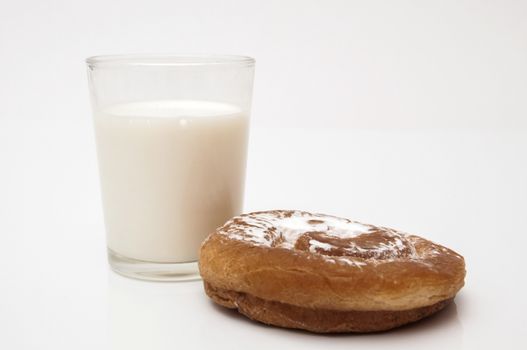 ensaimada glass of milk with sugar on a white background