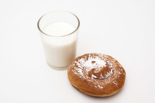ensaimada glass of milk with sugar on a white background
