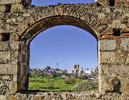 Merida, November 2012. Roman aqueduct ruins in Merida, capital of Extremadura region in Spain. I century. UNESCO World Heritage Site. Detail, Merida viewed throgh an arch.