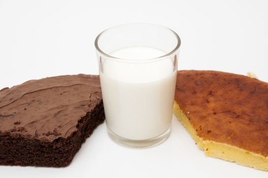 glass of milk with different cakes on a white background