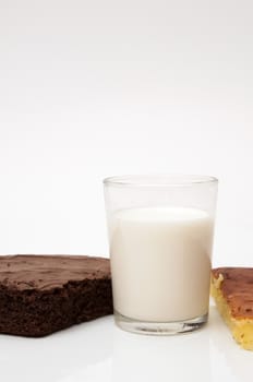 glass of milk with different cakes on a white background