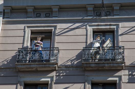 dolls on the balconies in a building in Barcelona