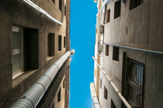 between buildings watching the sky with hardly any space